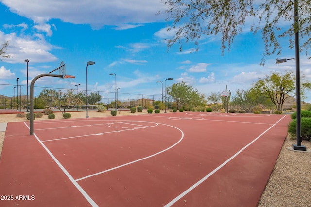 view of basketball court featuring community basketball court and fence