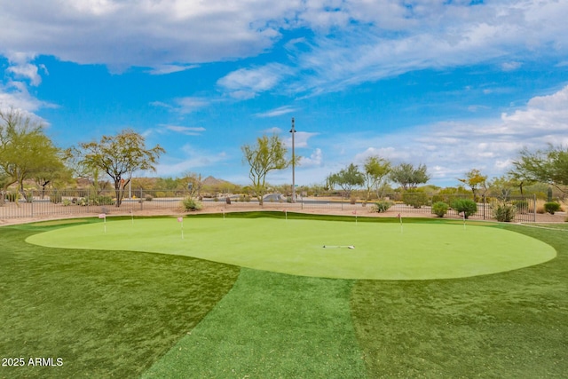 view of community with fence and view of golf course