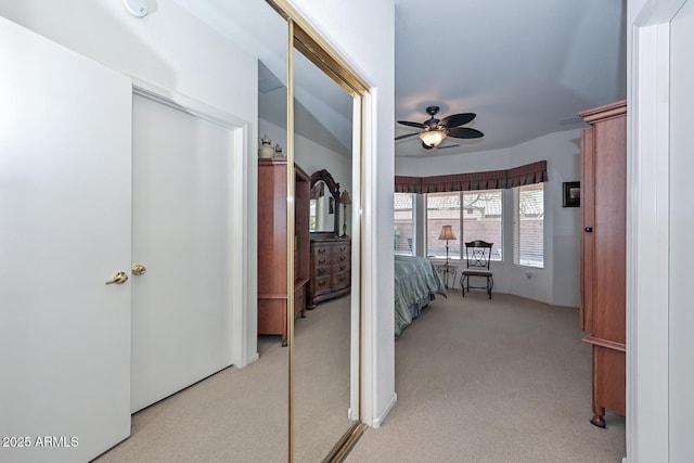 hallway featuring light colored carpet