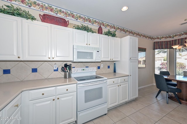 kitchen with light countertops, white appliances, white cabinets, and decorative backsplash