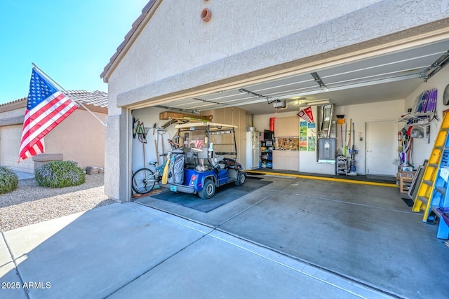 garage featuring electric panel and a garage door opener