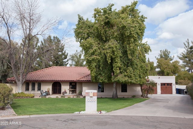 view of front of property featuring a garage and a front lawn