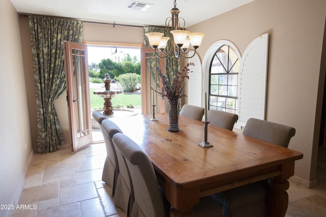 dining space with a notable chandelier