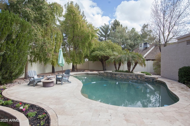 view of pool featuring a patio area and a fire pit