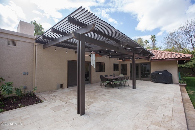 view of patio with area for grilling and a pergola