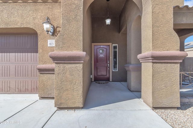 view of exterior entry featuring a garage