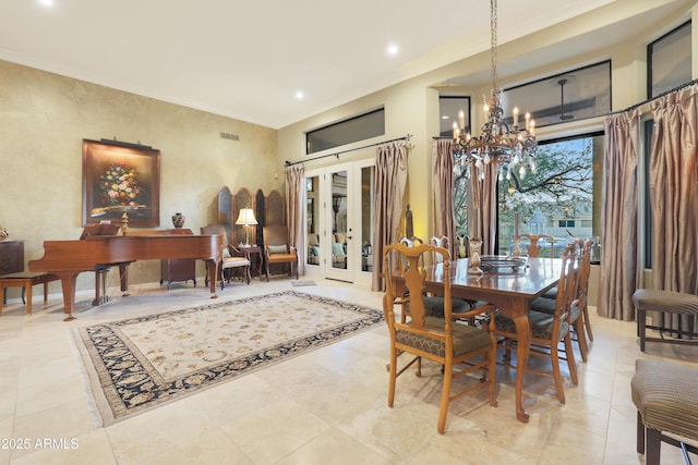 dining space with french doors and a chandelier