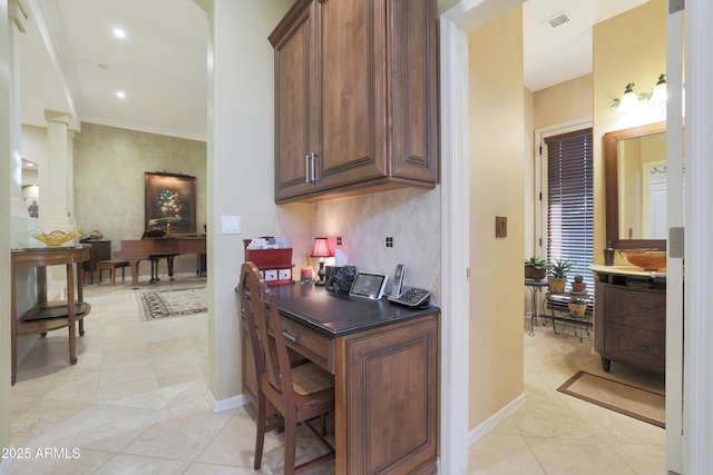 home office with light tile patterned floors and crown molding