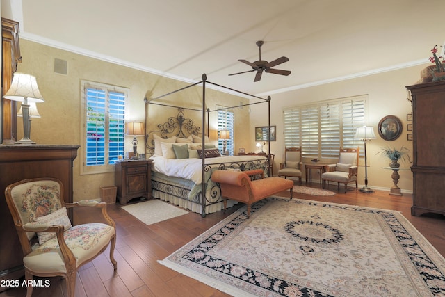 bedroom with ceiling fan, dark hardwood / wood-style flooring, and ornamental molding