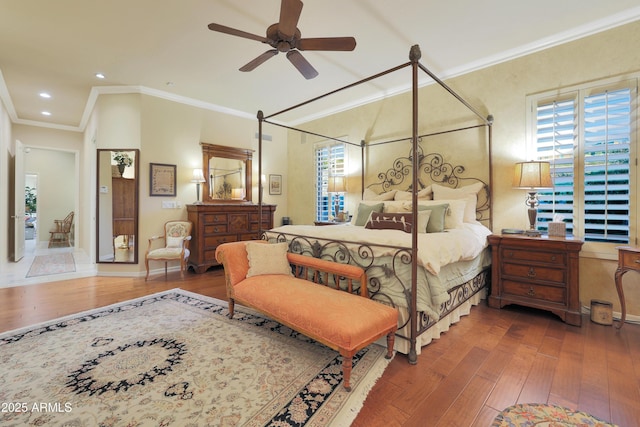 bedroom with hardwood / wood-style floors, ceiling fan, and crown molding