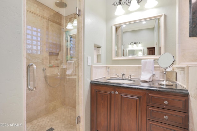 bathroom featuring decorative backsplash, vanity, and an enclosed shower