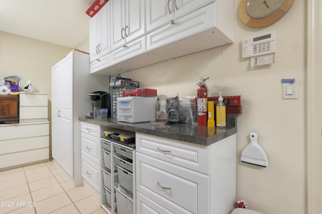 kitchen with white cabinets and light tile patterned floors