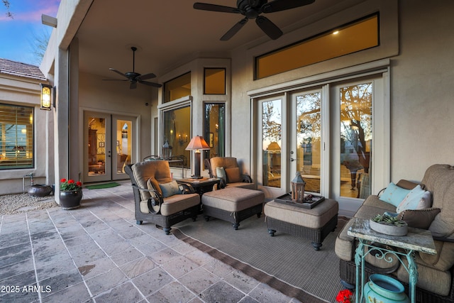 patio terrace at dusk featuring ceiling fan and french doors