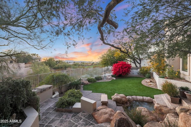 yard at dusk with a patio