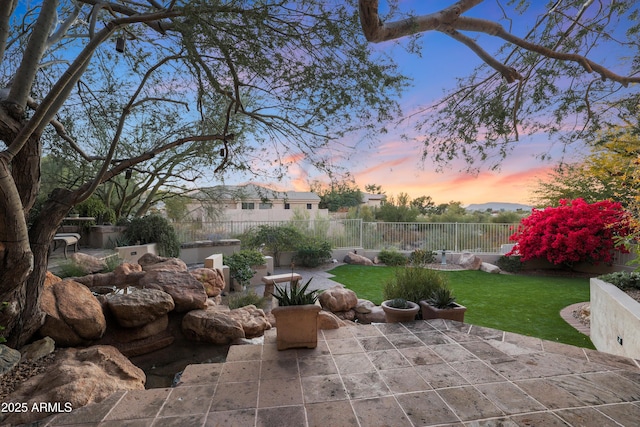 patio terrace at dusk with a lawn