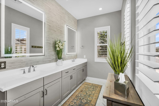 11233 N Blakely St, Surprise, AZ 85388 - full bath with healthy amount of natural light, double vanity, baseboards, tasteful backsplash, and recessed lighting