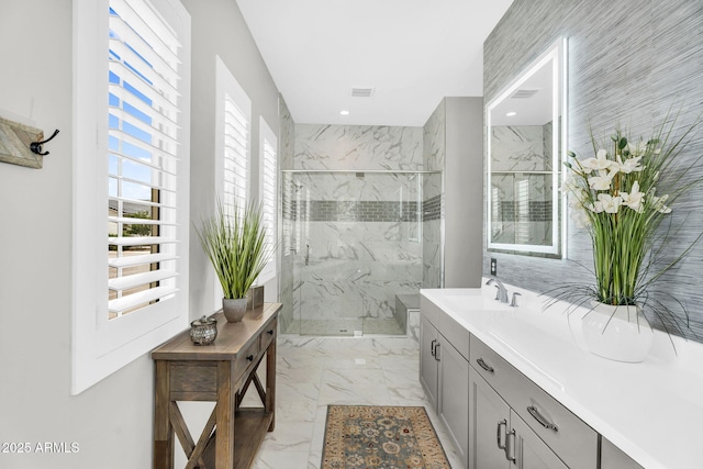 11233 N Blakely St, Surprise, AZ 85388 - full bathroom with marble look tile flooring, vanity, and a marble finish shower