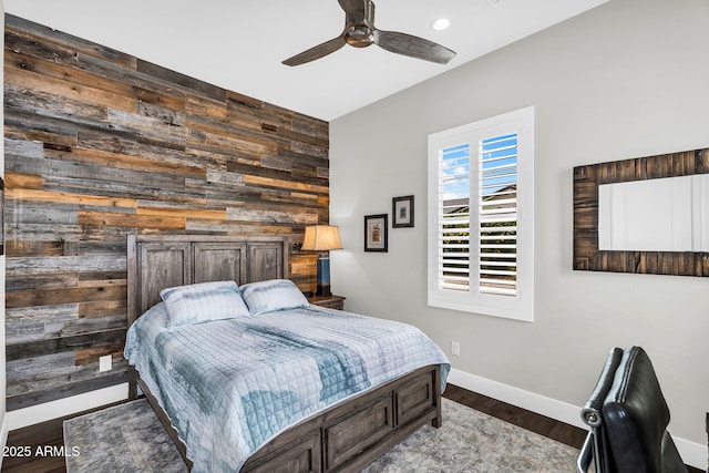 11233 N Blakely St, Surprise, AZ 85388 - bedroom with wooden walls, wood finished floors, baseboards, ceiling fan, and recessed lighting