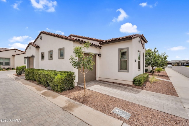 11233 N Blakely St, Surprise, AZ 85388 - view of front of house with a garage, a tiled roof, driveway, and stucco siding