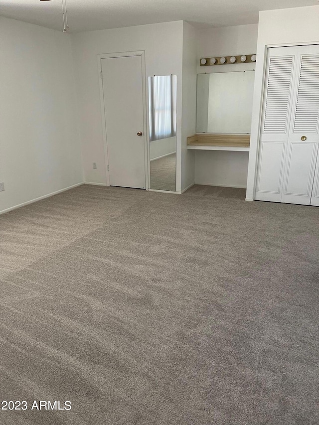 unfurnished room featuring light carpet and ceiling fan