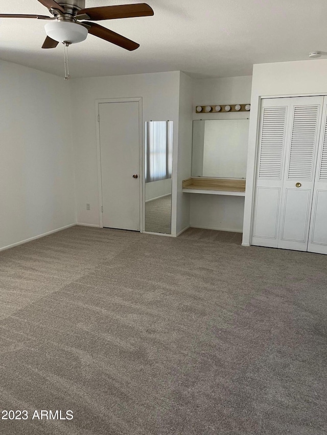 unfurnished bedroom featuring ceiling fan and light carpet