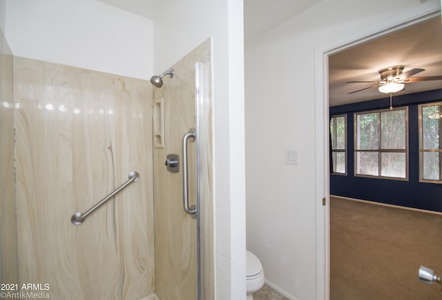 bathroom featuring walk in shower, ceiling fan, and toilet