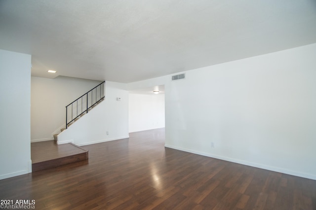 empty room with dark wood-type flooring