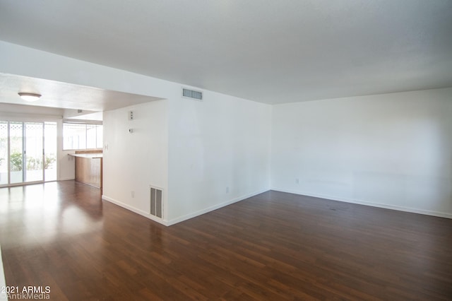 spare room featuring dark hardwood / wood-style flooring