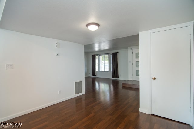 unfurnished room featuring dark hardwood / wood-style flooring
