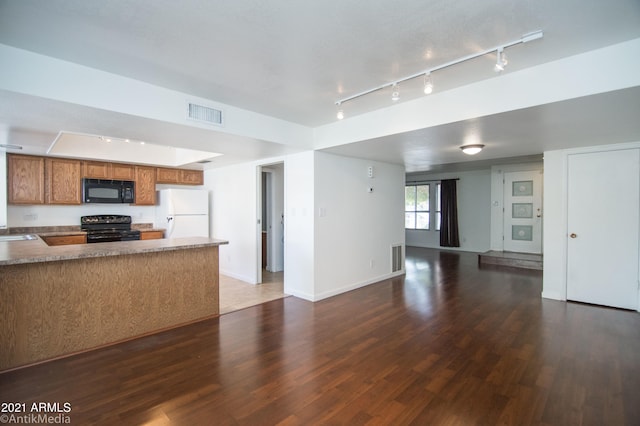 kitchen featuring dark hardwood / wood-style floors, kitchen peninsula, range with electric stovetop, white refrigerator, and rail lighting