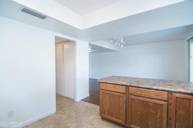 kitchen with rail lighting and light hardwood / wood-style floors