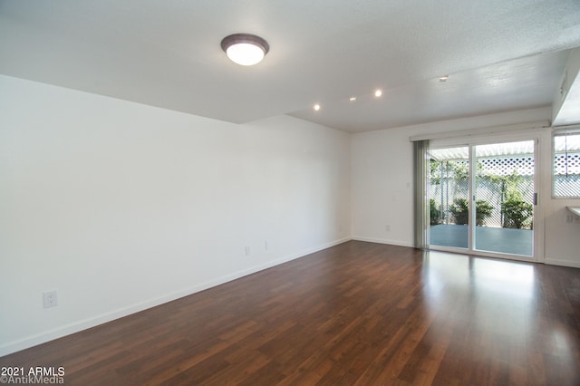 spare room featuring dark wood-type flooring