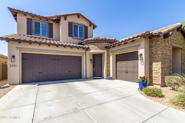 3751 E Zachary Dr, Phoenix, AZ 85050 - mediterranean / spanish-style house featuring concrete driveway, stucco siding, stone siding, a tile roof, and a garage