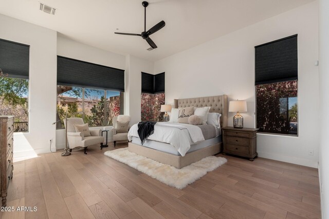 bedroom with wood finished floors, baseboards, and ceiling fan