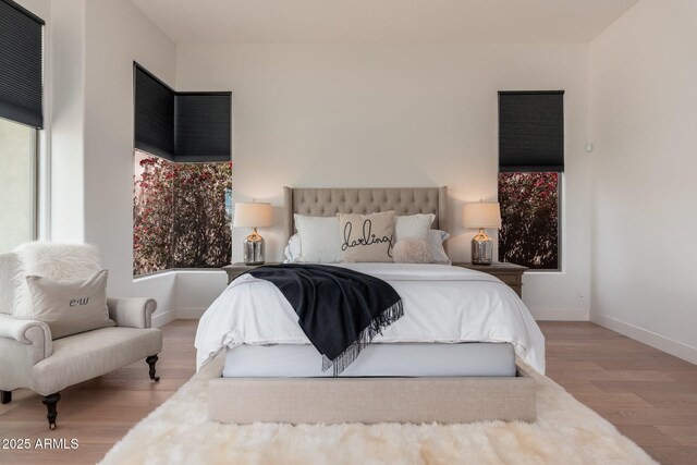 bedroom featuring wood finished floors and baseboards