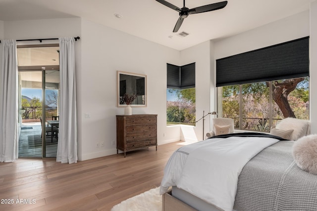 bedroom featuring access to outside, light wood finished floors, baseboards, and ceiling fan