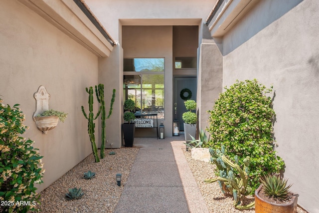entrance to property featuring stucco siding