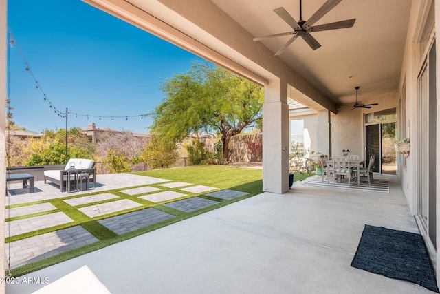 view of patio with a ceiling fan and outdoor dining area