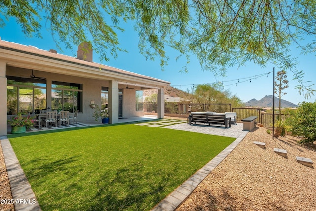 view of yard with a patio and a ceiling fan