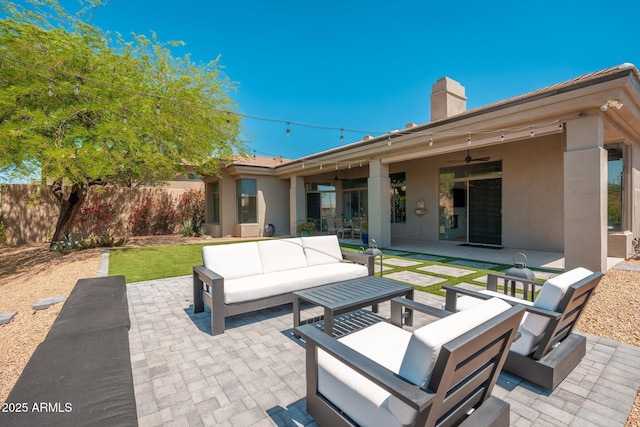 view of patio with outdoor lounge area, ceiling fan, and fence
