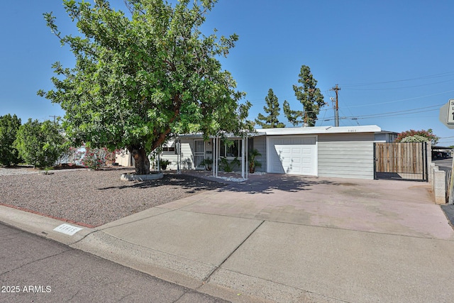 11815 N 112th Dr, Youngtown, AZ 85363 - view of front of property featuring an attached garage, concrete driveway, and fence