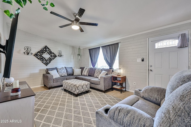 11815 N 112th Dr, Youngtown, AZ 85363 - living room featuring a ceiling fan, crown molding, healthy amount of natural light, light wood-style floors, and brick wall
