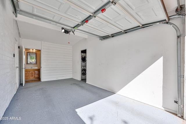 11815 N 112th Dr, Youngtown, AZ 85363 - garage featuring estacked washer and dryer and a garage door opener