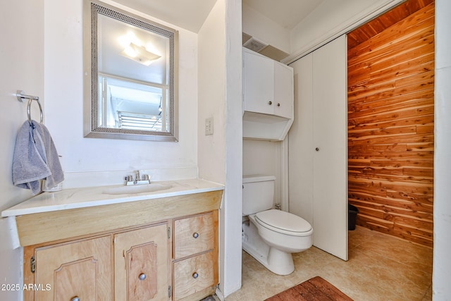 11815 N 112th Dr, Youngtown, AZ 85363 - bathroom with toilet, wooden walls, and vanity