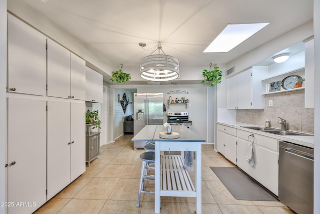 11815 N 112th Dr, Youngtown, AZ 85363 - kitchen featuring appliances with stainless steel finishes, open shelves, a sink, white cabinets, and light tile patterned floors