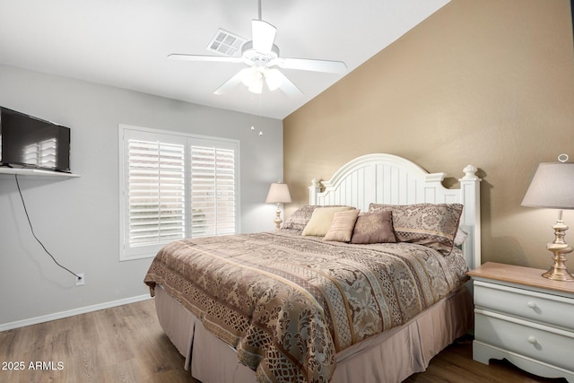 bedroom featuring ceiling fan, lofted ceiling, and light hardwood / wood-style flooring