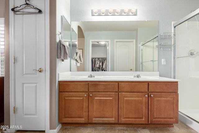 bathroom with walk in shower and vanity