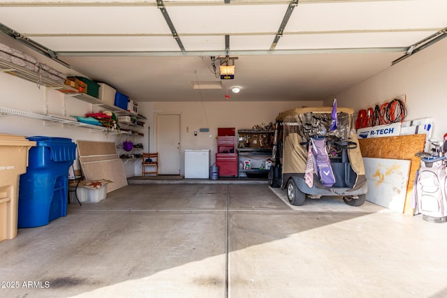 garage featuring refrigerator and a garage door opener