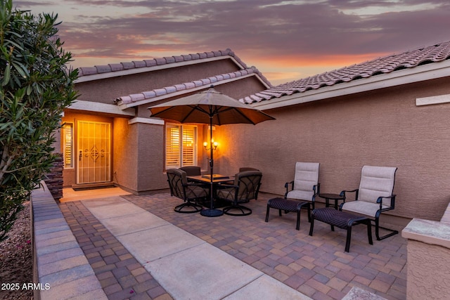 view of patio terrace at dusk