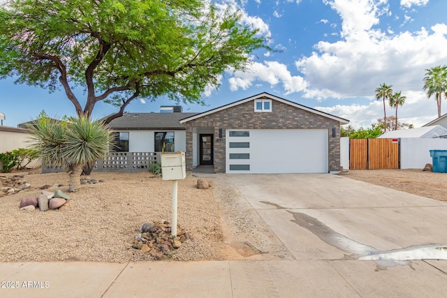 4019 E Surrey Ave, Phoenix, AZ 85032 - single story home with concrete driveway, fence, an attached garage, and a gate